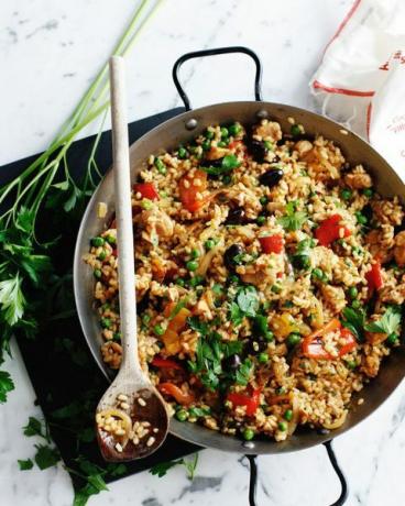 Wok con paella di pollo con verdure e prezzemolo