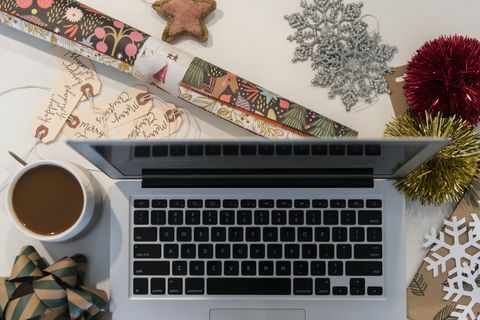 Laptop, caffè, carta da regalo e ornamenti natalizi